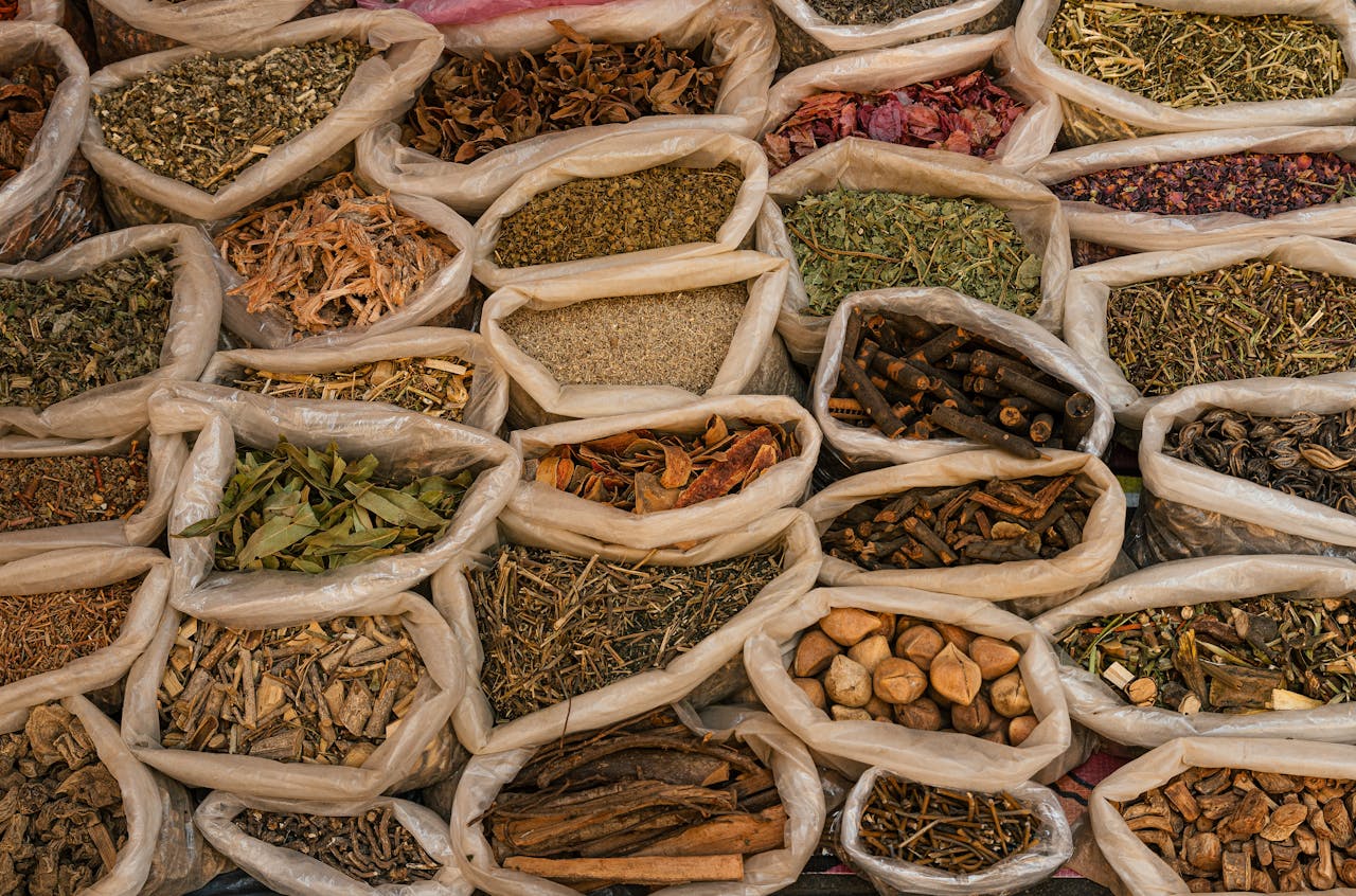 The Art of Drawing Readers In: Your attractive post title goes here Bags filled with various dried herbs and spices displayed in a traditional market setting.